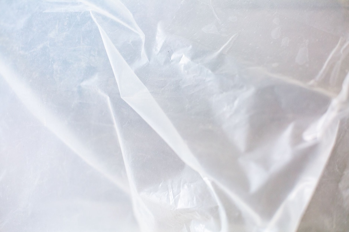 DIY plastic film shrink wrap applied to a window frame for insulation.